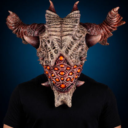 Aurixis mask, view 2, against a smooth dark blue-teal gradient background
