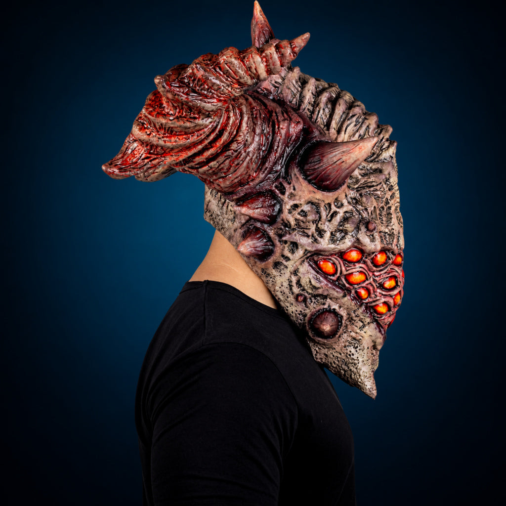 Aurixis mask, view 4, against a smooth dark blue-teal gradient background