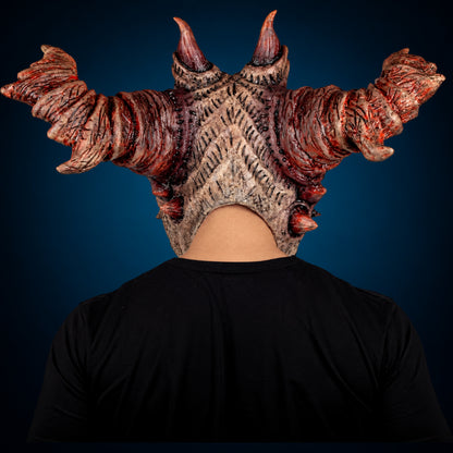 Aurixis mask, view 5, against a smooth dark blue-teal gradient background