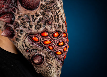 Aurixis mask, view 6, against a smooth dark blue-teal gradient background