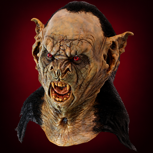 Bram Stoker’s Dracula BAT mask against a smooth dark burgundy gradient background