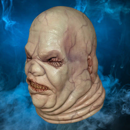 Butterball Hellraiser mask – view 3 with blue smoke background matching the original hero image