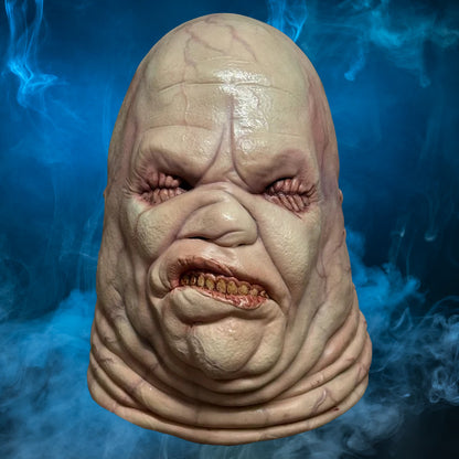 Butterball Hellraiser mask – view 4 with blue smoke background matching the original hero image