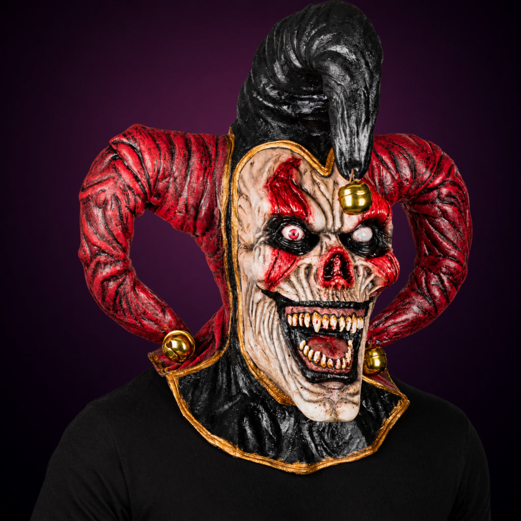 Evil Jester mask, view 3, against a smooth dark plum-charcoal gradient background