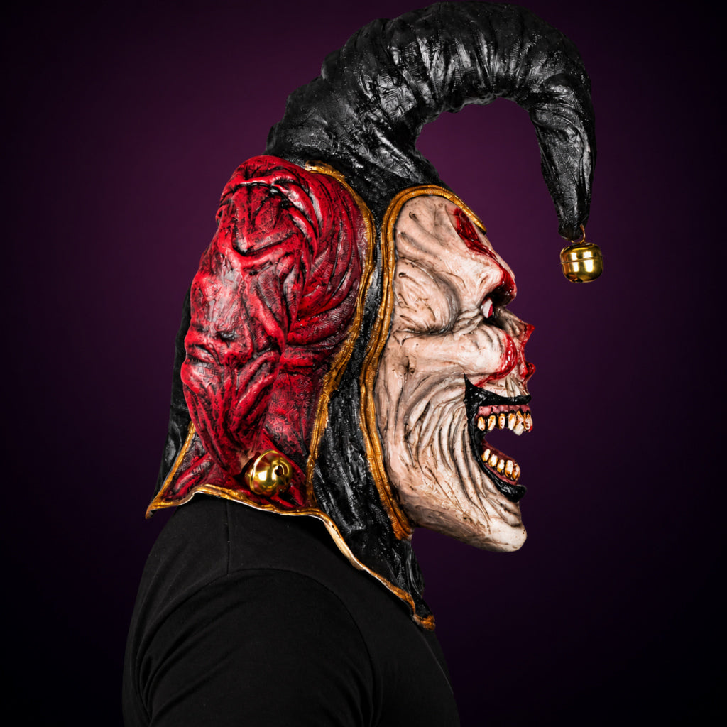 Evil Jester mask, view 4, against a smooth dark plum-charcoal gradient background