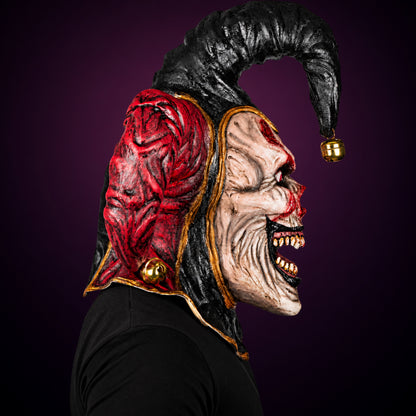 Evil Jester mask, view 4, against a smooth dark plum-charcoal gradient background