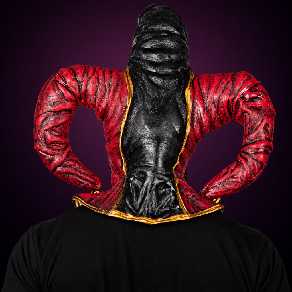 Evil Jester mask, view 5, against a smooth dark plum-charcoal gradient background