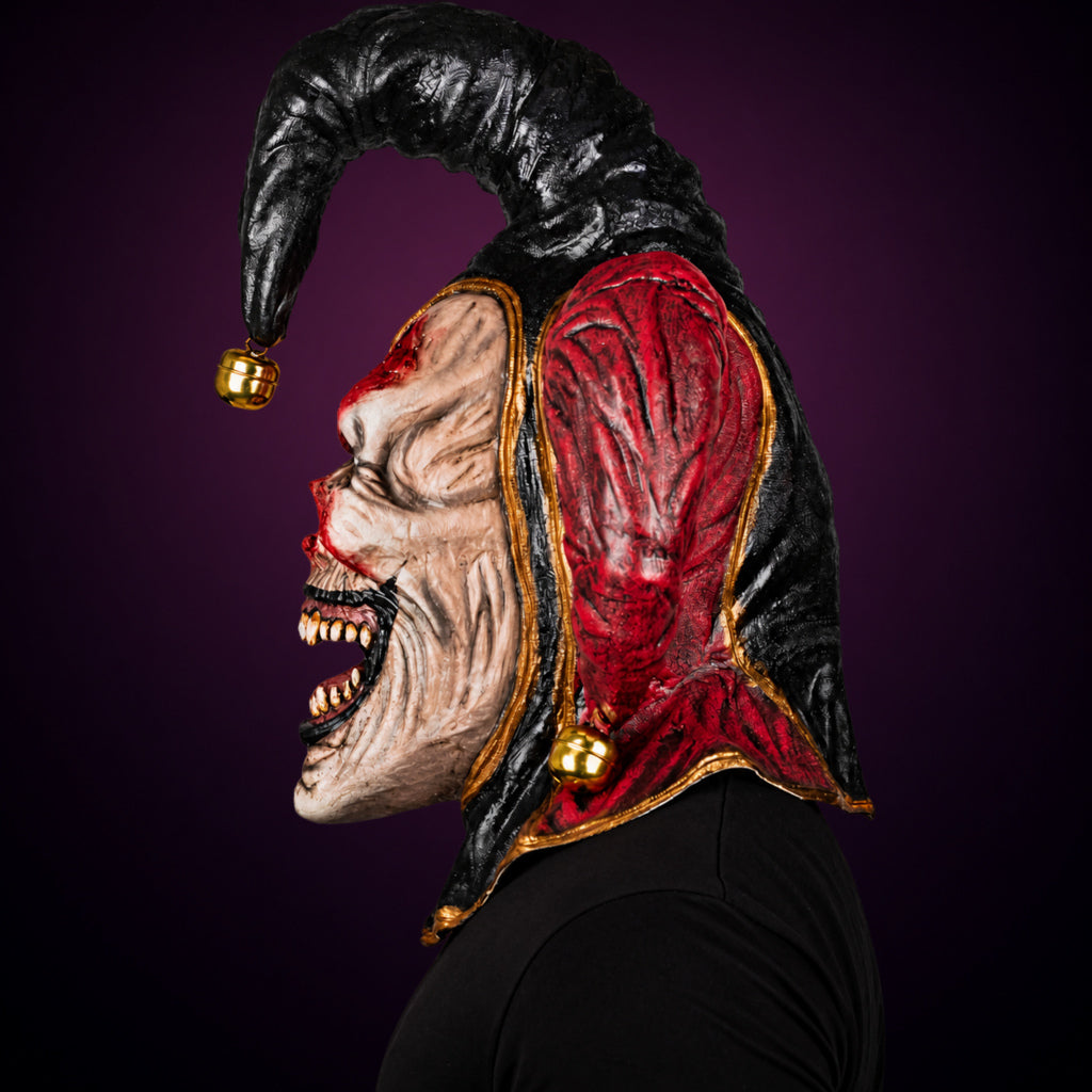 Evil Jester mask, view 6, against a smooth dark plum-charcoal gradient background