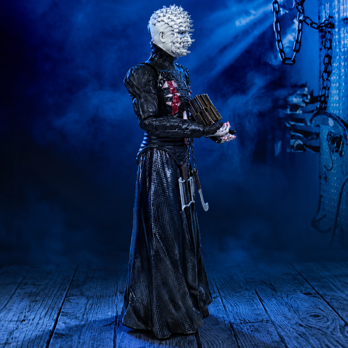 Pinhead 8-inch Hellraiser figure, right-facing side view against a blue industrial background