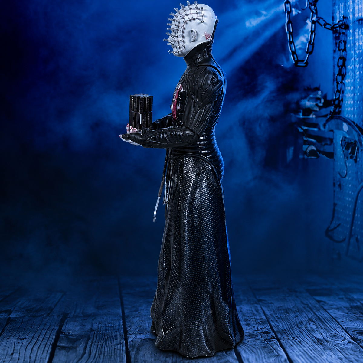 Pinhead 8-inch Hellraiser figure, left-facing side view against a blue industrial background
