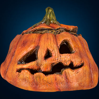 Rotten Pumpkin 3 decoration, view 1, against a smooth dark blue-teal gradient background