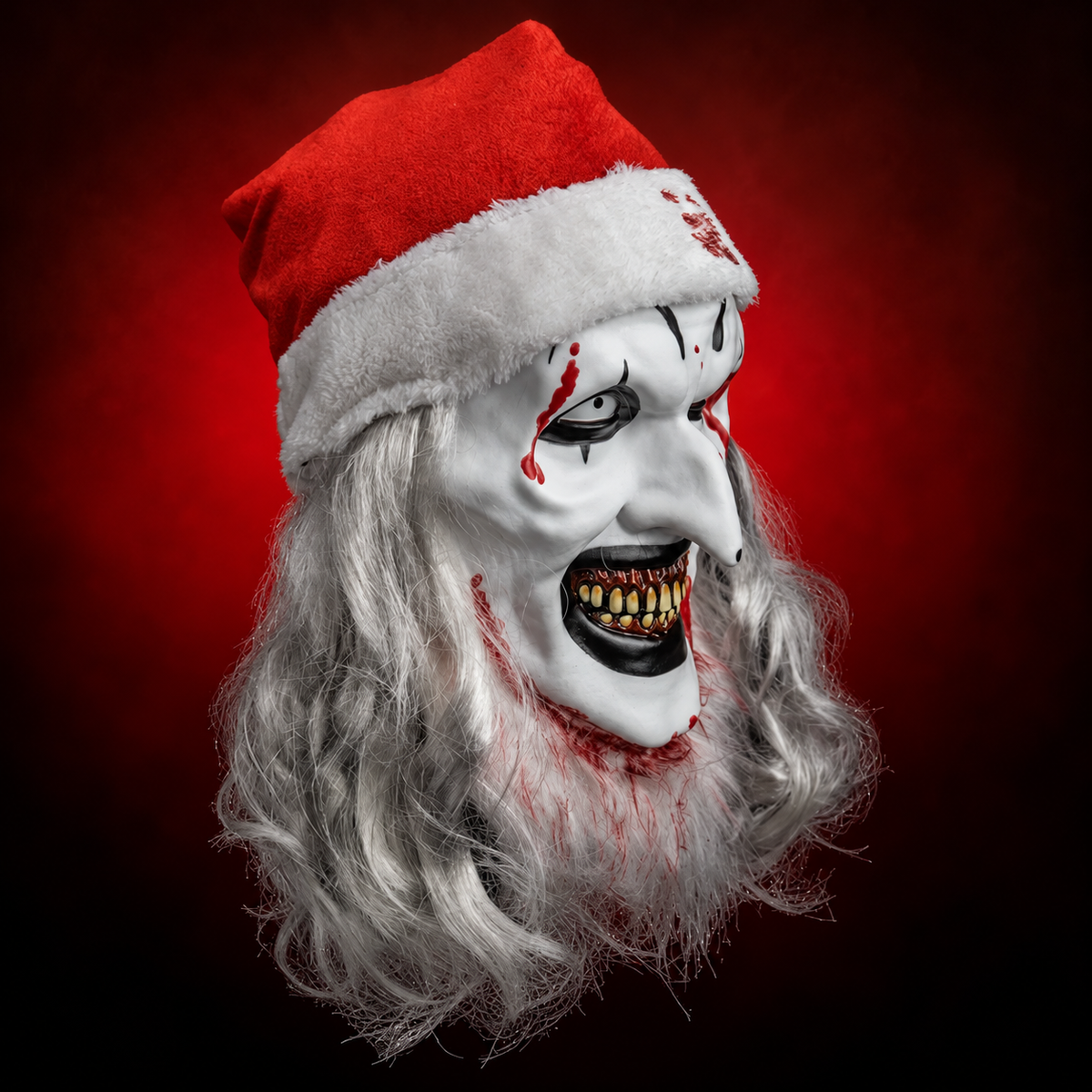 Santa Art the Clown Deluxe Injection Mask from Terrifier 3, right-facing angled view against red radiant background