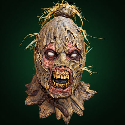 Scareborn mask, view 1, against a smooth dark forest-green gradient background