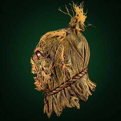 Scareborn mask, view 2, against a smooth dark forest-green gradient background