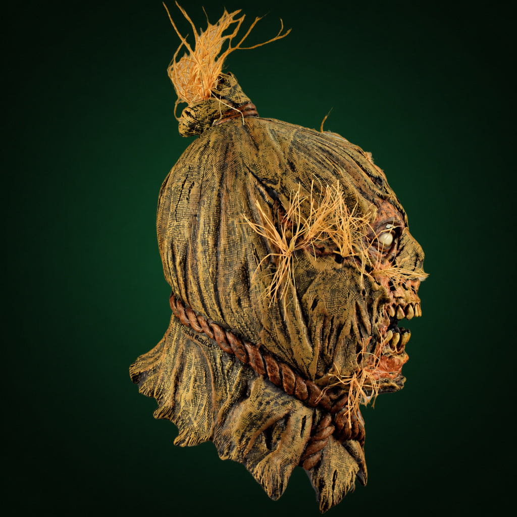Scareborn mask, view 4, against a smooth dark forest-green gradient background