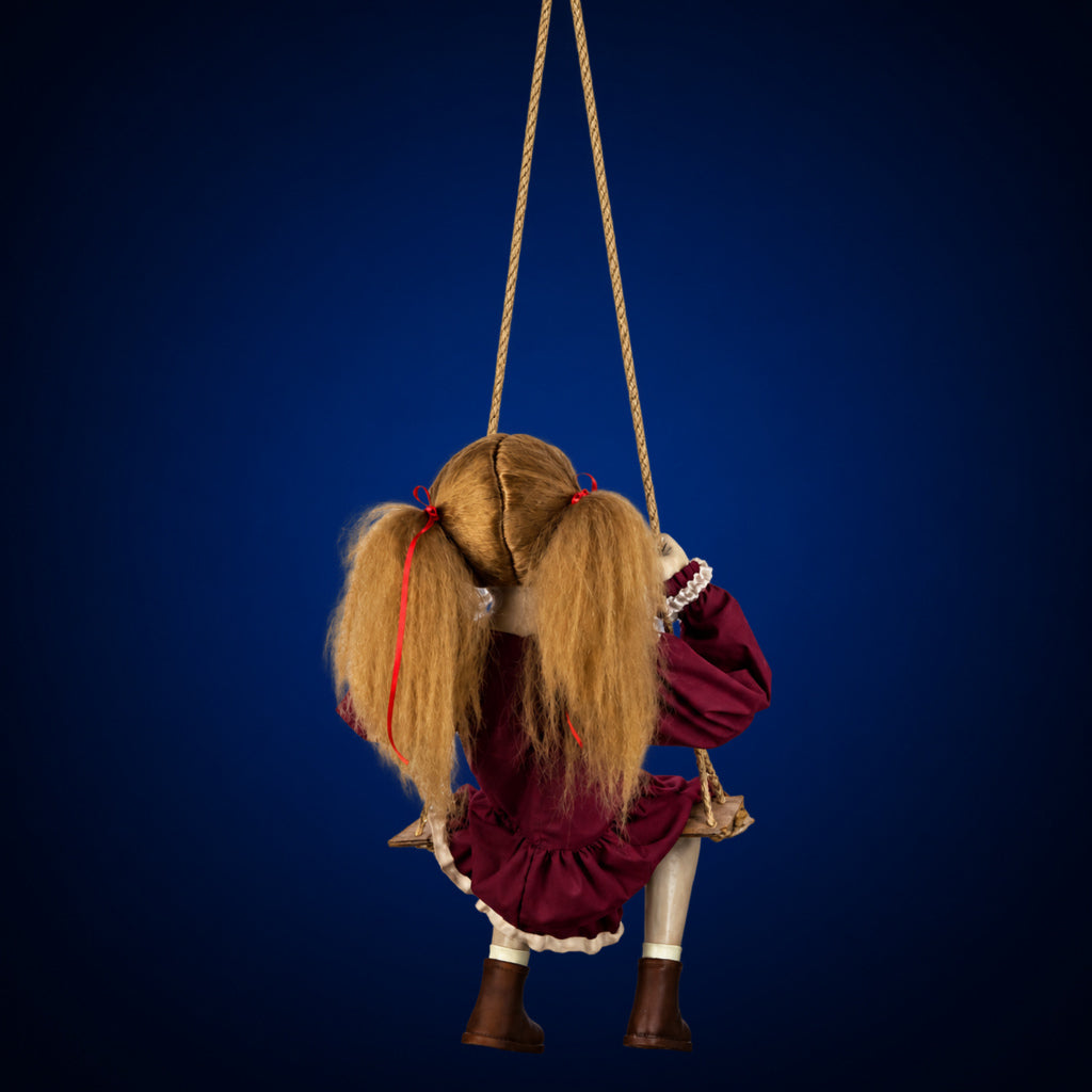 Swinging Ghostly Girl decoration, view 2, against a smooth dark midnight-blue gradient background