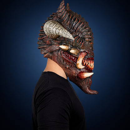 Wrath mask, view 4, against a smooth dark steel-blue gradient background
