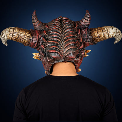 Wrath mask, view 5, against a smooth dark steel-blue gradient background