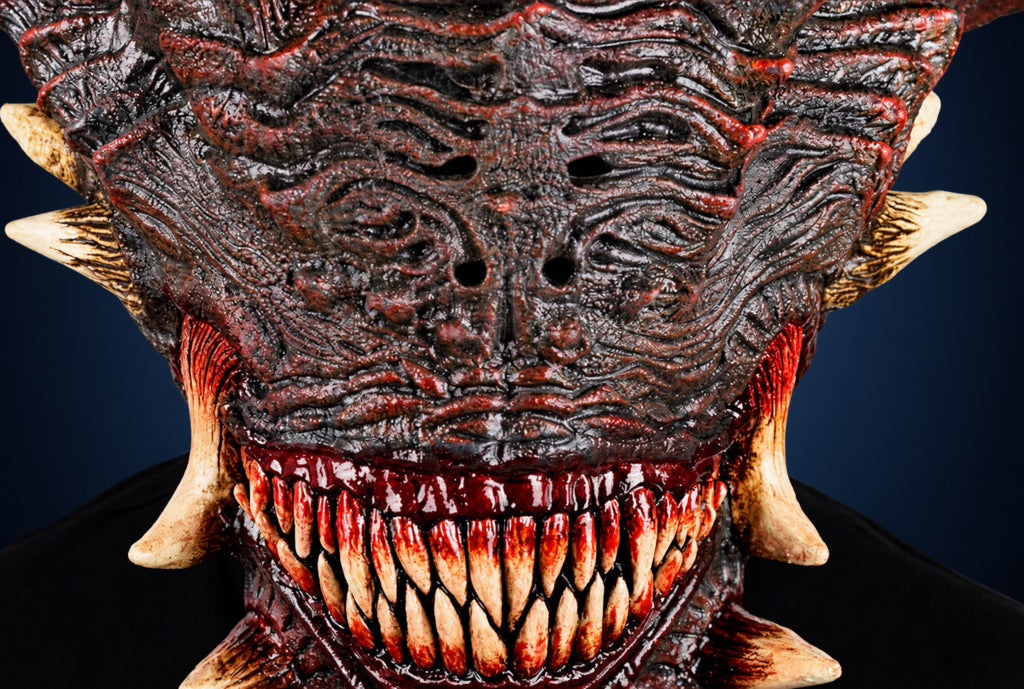Wrath mask, view 6, against a smooth dark steel-blue gradient background